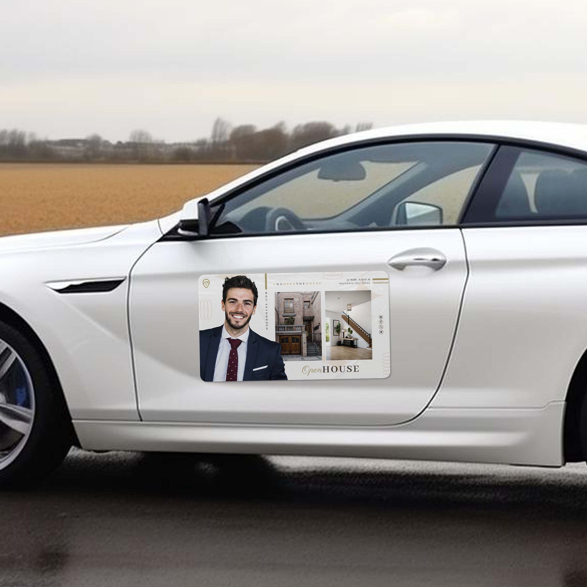 White car with a door decal featuring a real estate agent and house images.